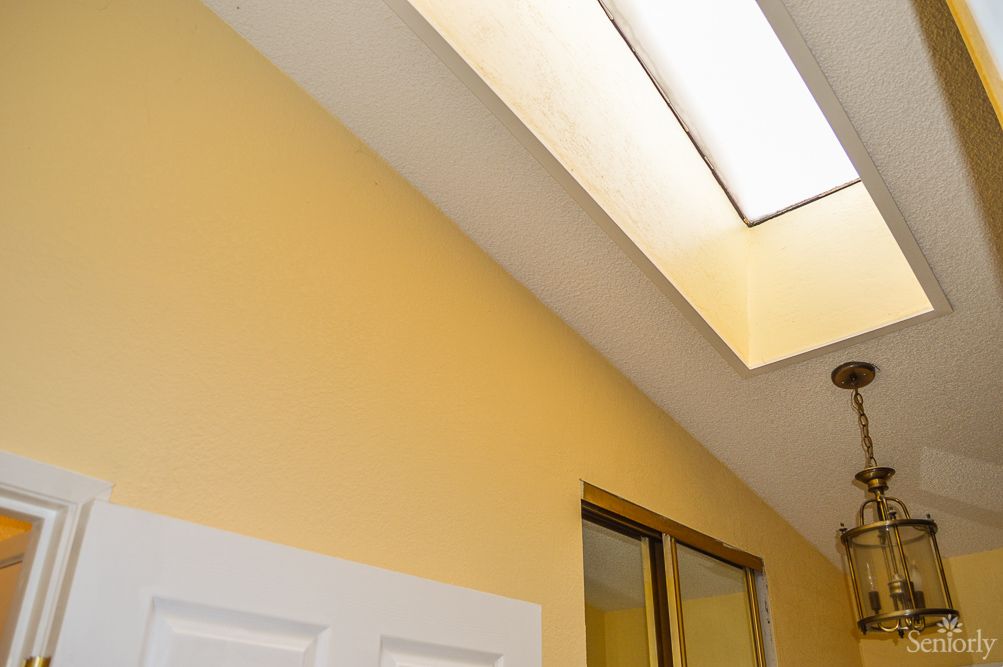 A view of an interior space featuring a skylight and a door.