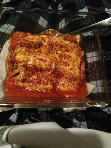 A delicious serving of homemade lasagna, baked to perfection.