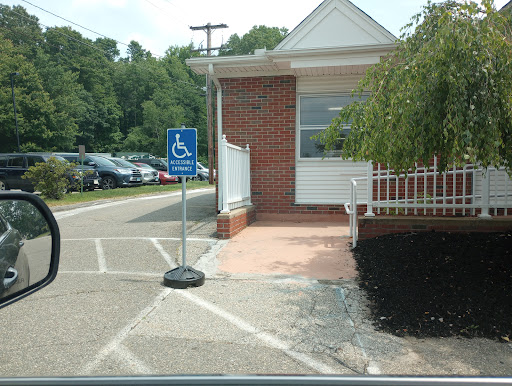 A designated handicapped parking area with an accessible entrance next to a building.