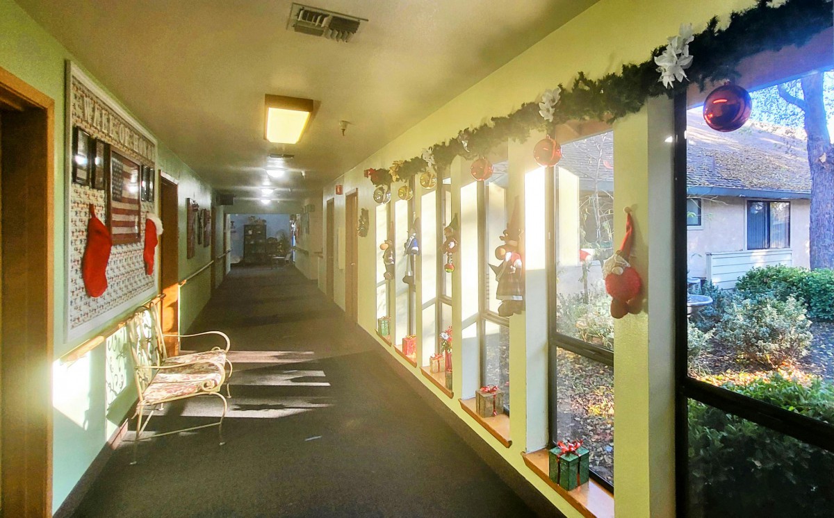 Sunlit hallway with festive decorations and seating.