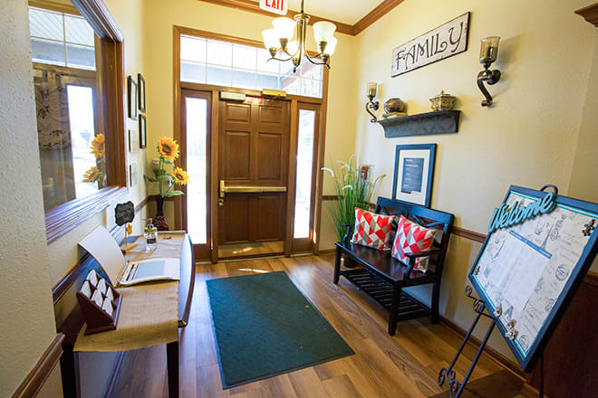 A cozy and inviting entryway with warm decor and wooden flooring.