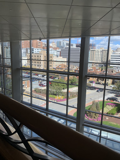 A view of the city skyline through large windows, showcasing urban architecture and bustling streets.