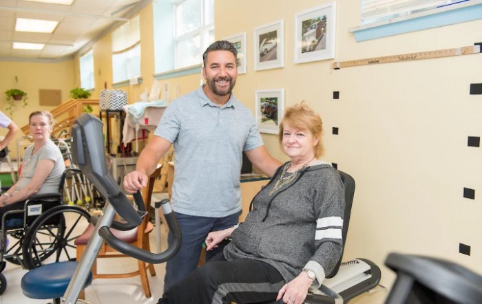 A physical therapist assists a patient during a rehabilitation session.