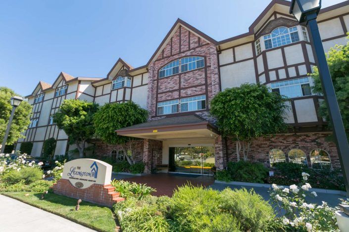 A scenic view of a charming hotel building surrounded by greenery.