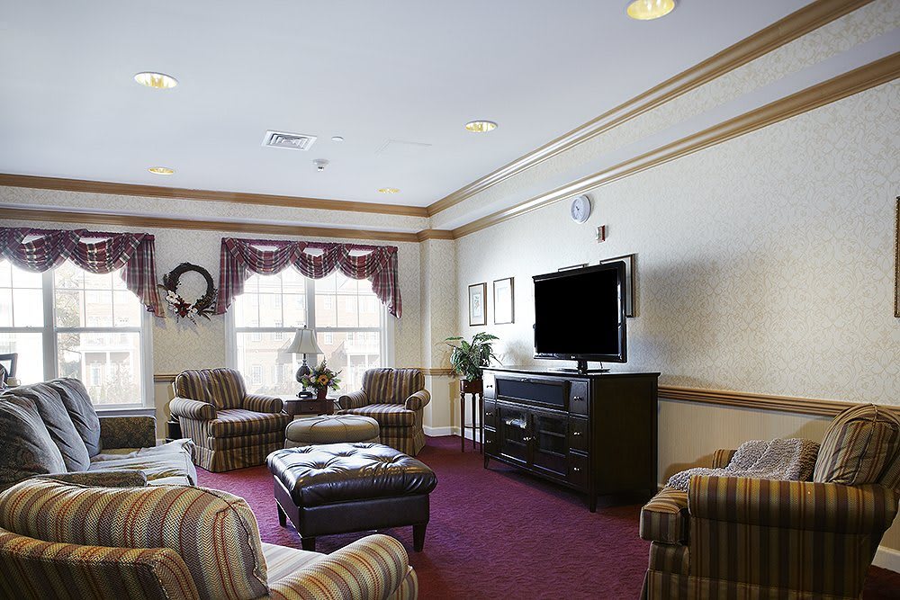 Comfortable living room with cozy seating and a TV.