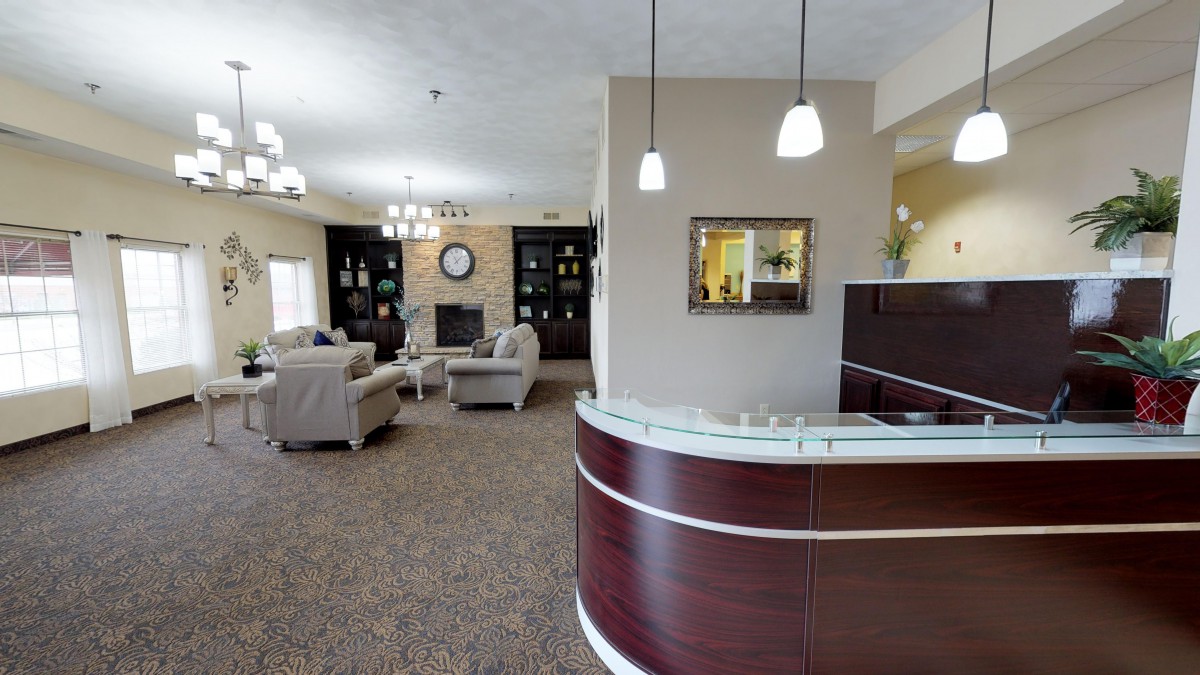 A modern lobby with a reception desk and comfortable seating area.