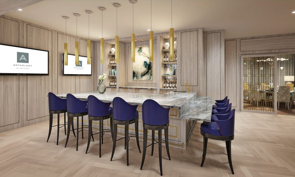 A modern bar area with blue chairs, elegant lighting, and contemporary artwork.