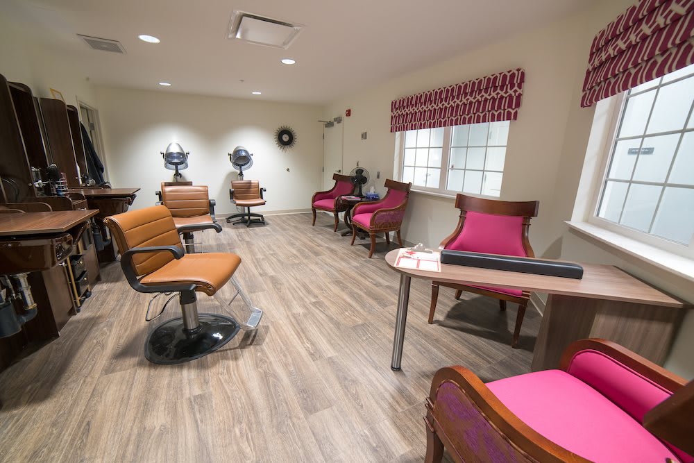 A well-lit hair salon with stylish chairs and modern decor.