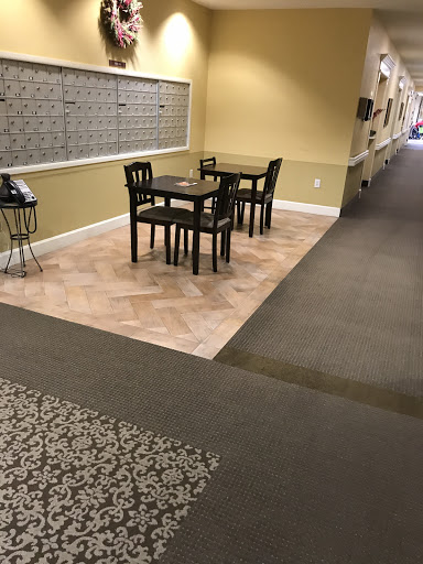 A cozy dining area with tables and chairs located in a hallway.