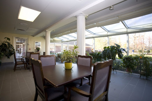 A bright and inviting dining area with a large wooden table, comfortable chairs, and plenty of natural light.