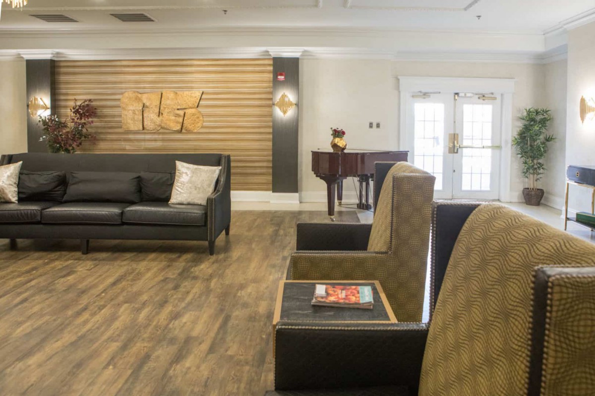 A modern lobby with comfortable seating and a piano.