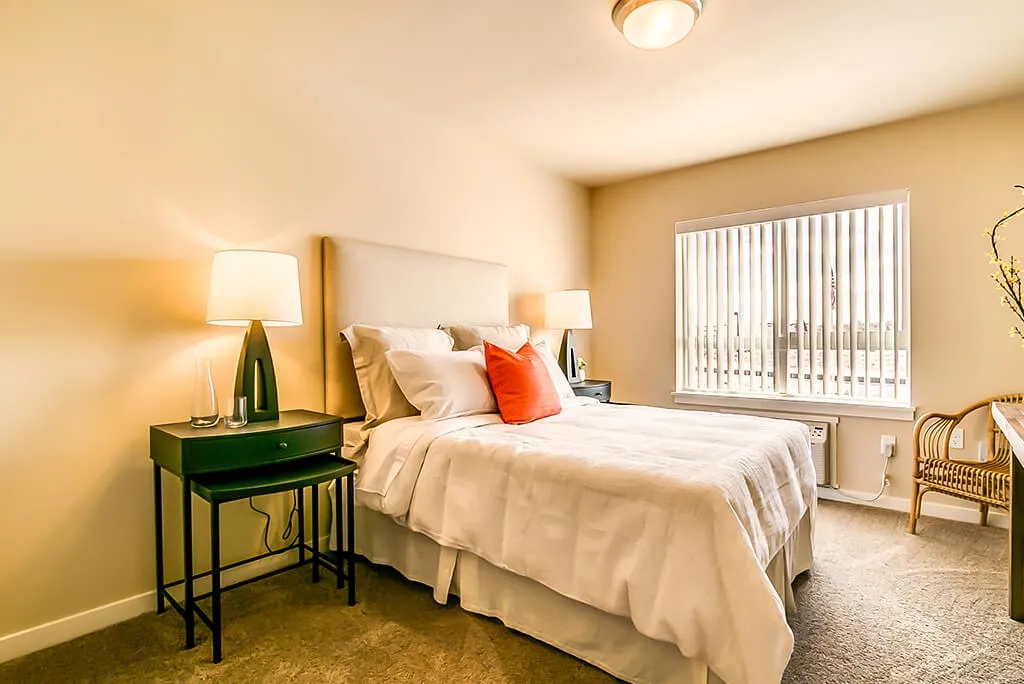 A cozy and modern bedroom with minimalistic decor, featuring a comfortable bed and stylish lamps.