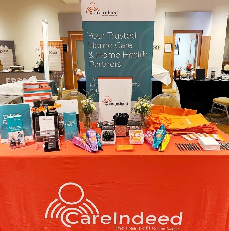 A trade show booth for CareIndeed showcasing promotional materials and information about their home care services.