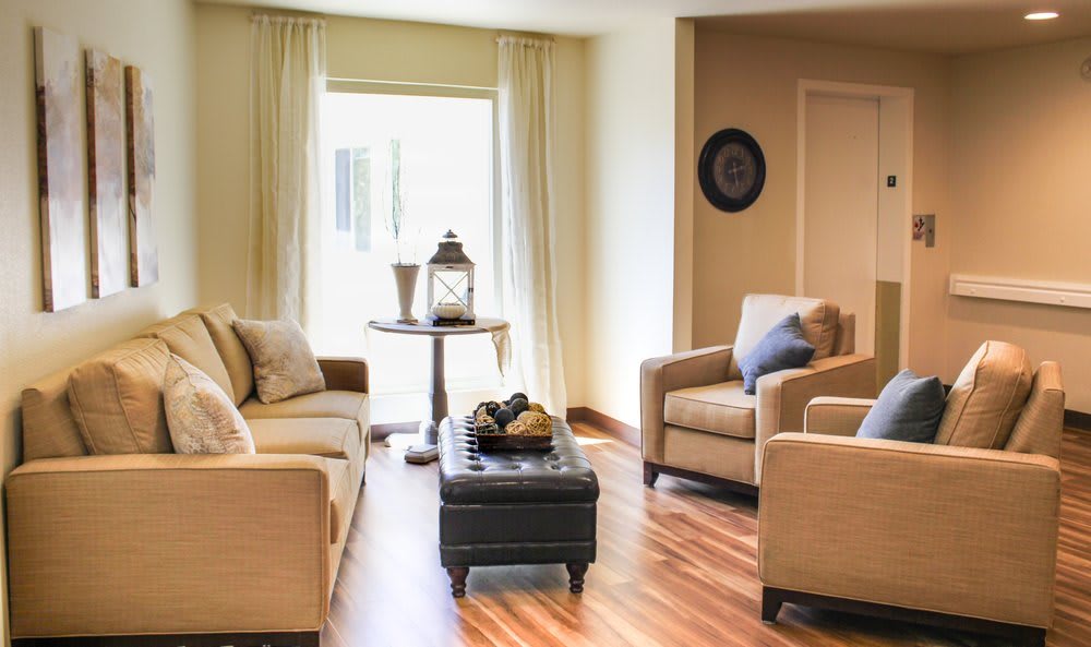 A cozy living room with neutral-toned furniture and warm decor.