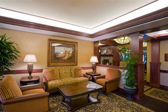 A cozy hotel lobby with a comfortable seating area and warm lighting.