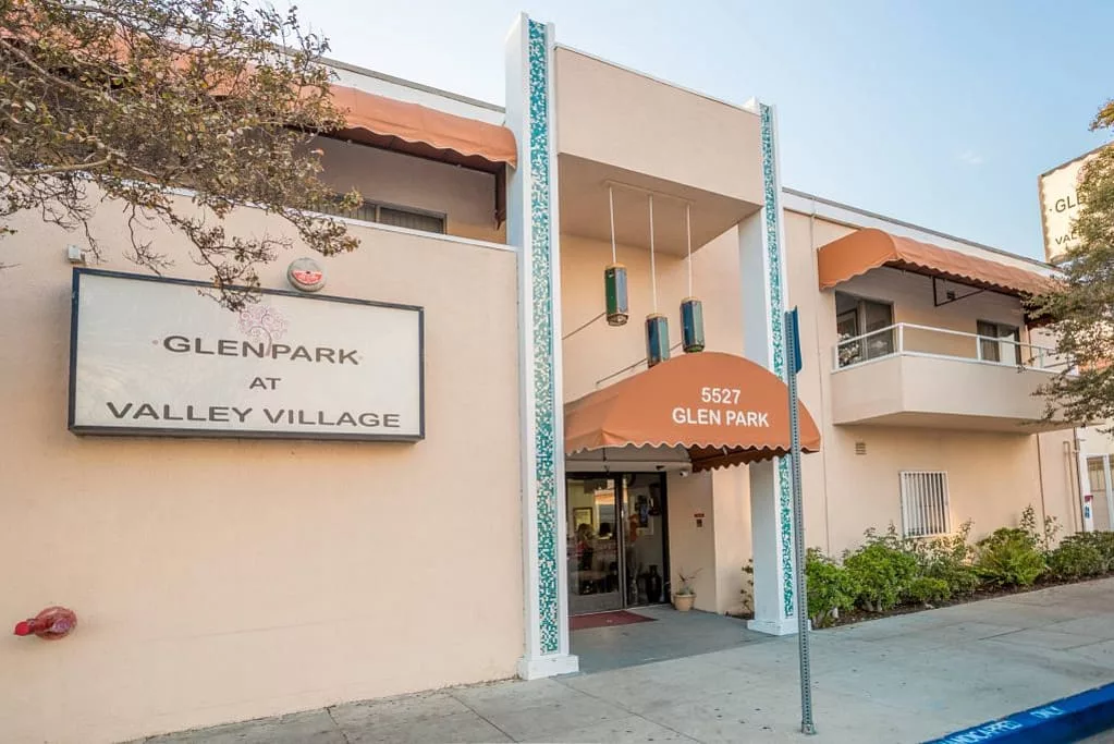 Entrance to a building with an awning and signage.