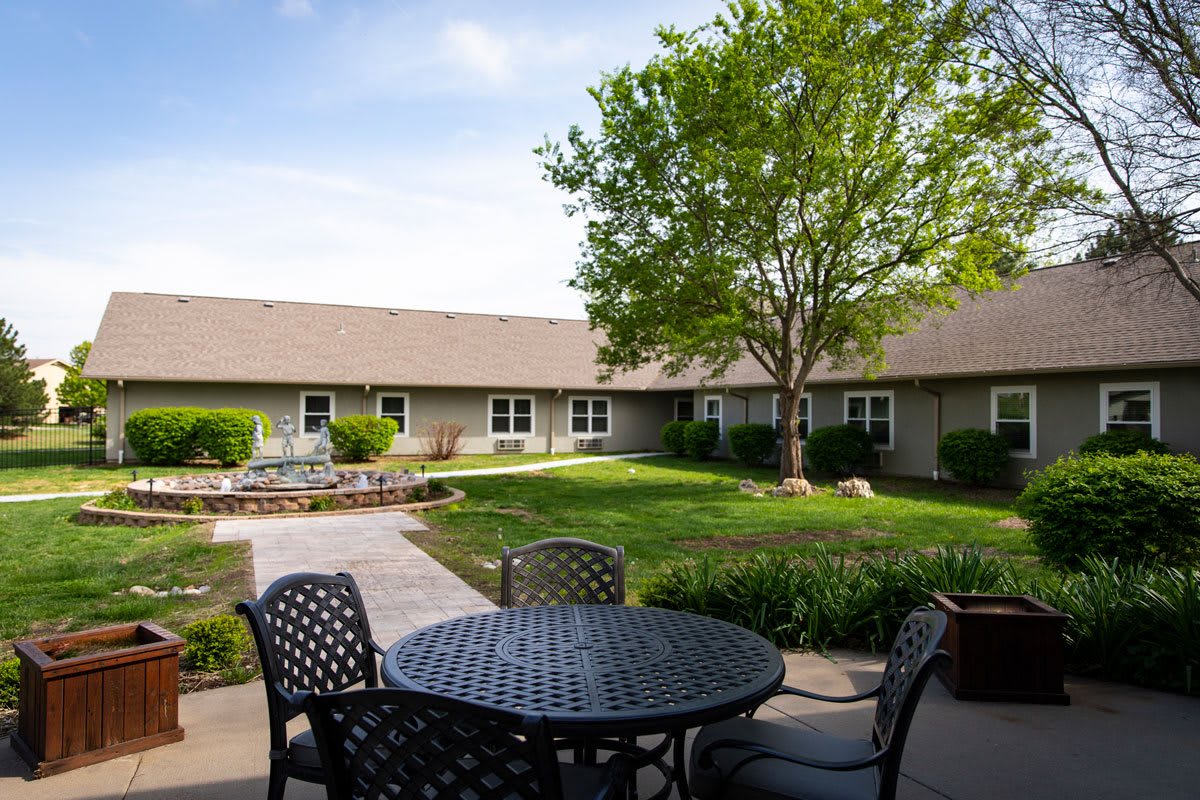 A peaceful courtyard with outdoor seating and a landscaped garden.