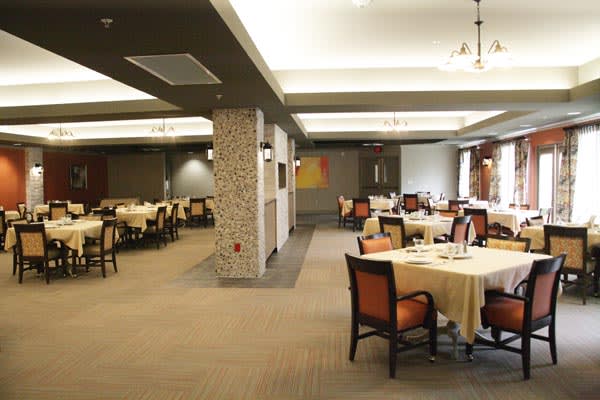 A modern restaurant dining area with neatly arranged tables and chairs.