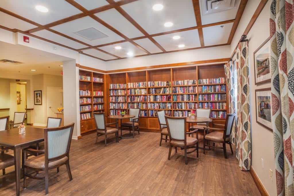 Cozy library reading area with bookshelves and seating.
