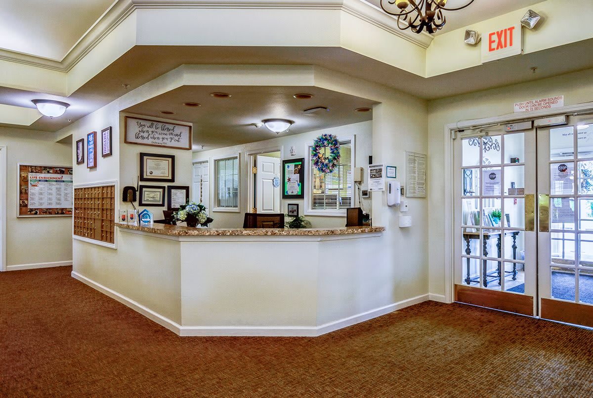 A welcoming reception area with a central desk and decorative elements on the walls.