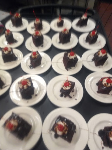 A delightful array of chocolate cakes, each topped with a cherry, ready to be enjoyed at a celebration.