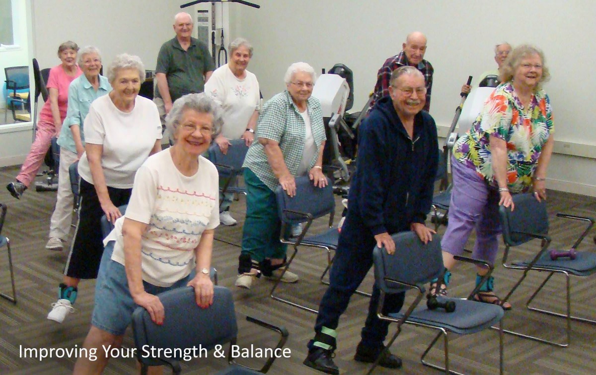 A group of seniors participating in a chair exercise class to improve strength and balance.
