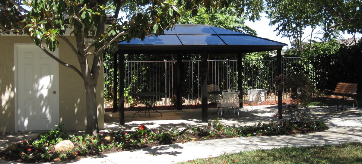 A gazebo surrounded by greenery in a landscaped garden.