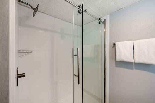 A sleek and modern glass shower enclosure in a stylish bathroom.