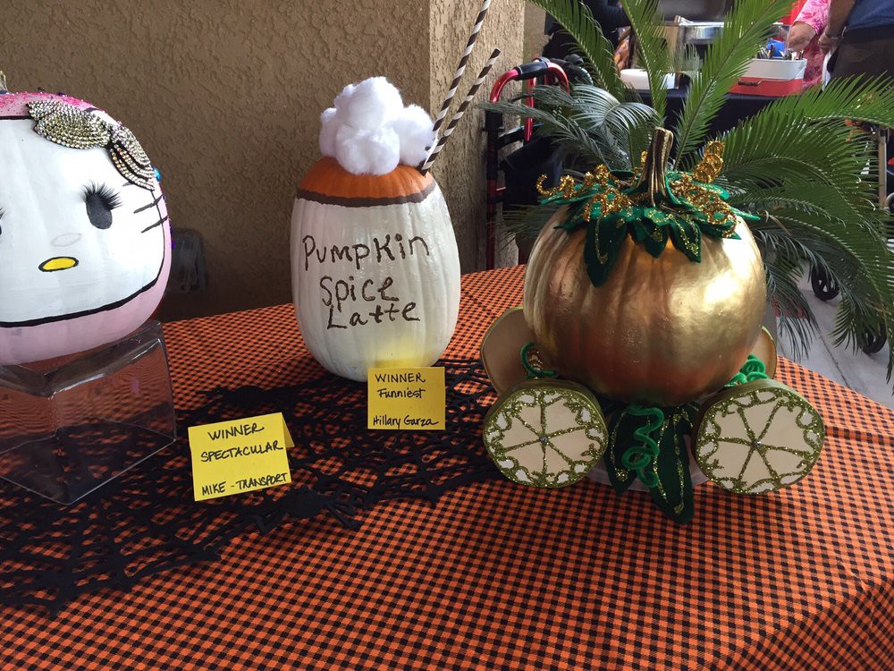 Creative pumpkin decorations with fall-themed designs on display.