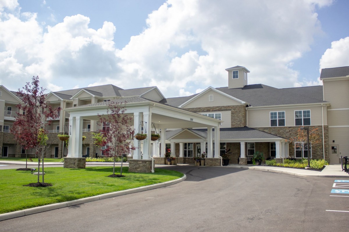 A modern residential or facility building with a covered entrance.