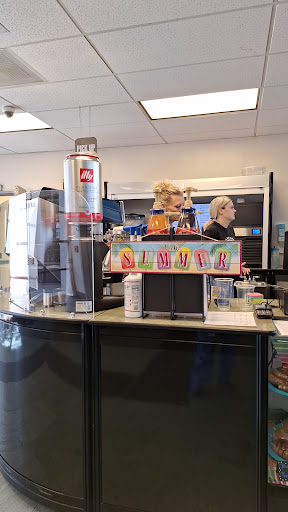 A busy fast food restaurant counter with employees serving customers.