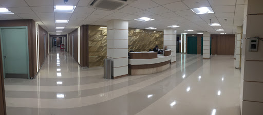 A modern office lobby with a reception desk and elegant interior design.