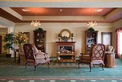An elegant living room with a cozy fireplace and traditional furnishings.