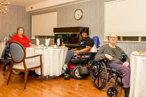 Residents enjoying time together in a care facility's dining area.