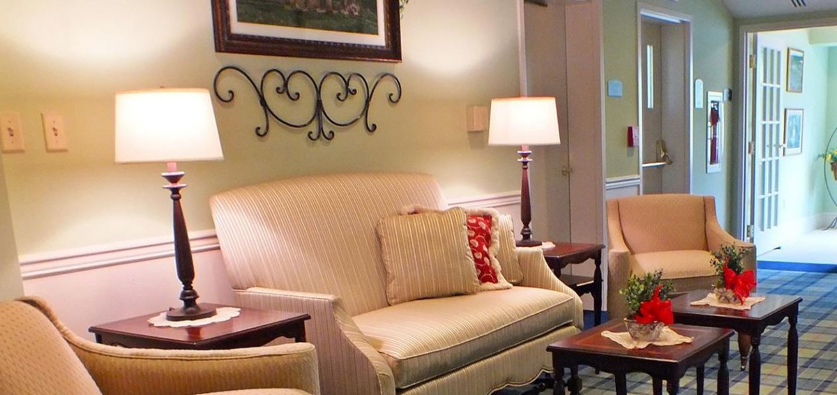 A cozy living room with a comfortable sofa, stylish lamps, and decorative elements.