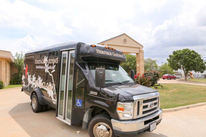 A black shuttle bus parked outside a building, labeled 'Texas Health Presbyterian Hospital.'