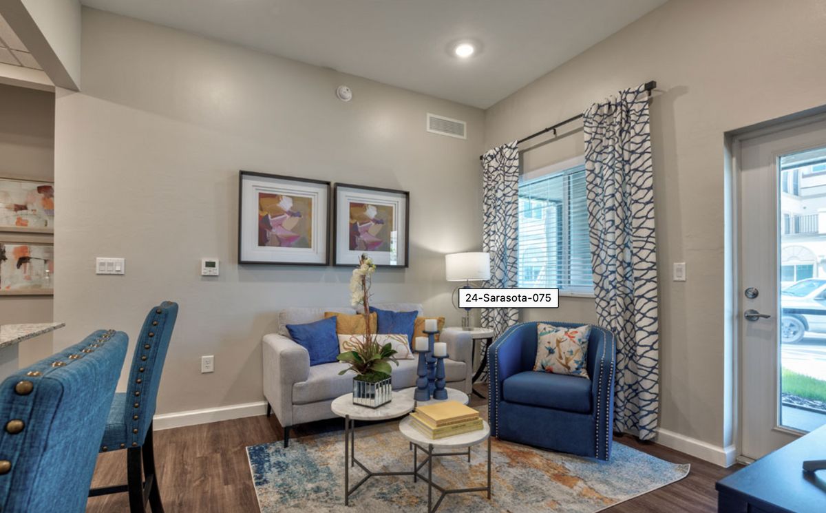 A cozy, modern living room with blue accents and contemporary furniture.