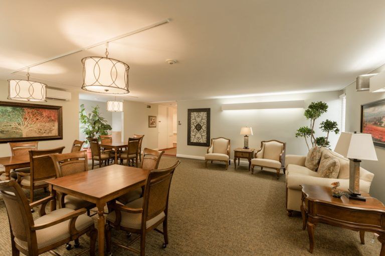 A spacious living and dining area with modern furnishings and soft lighting.