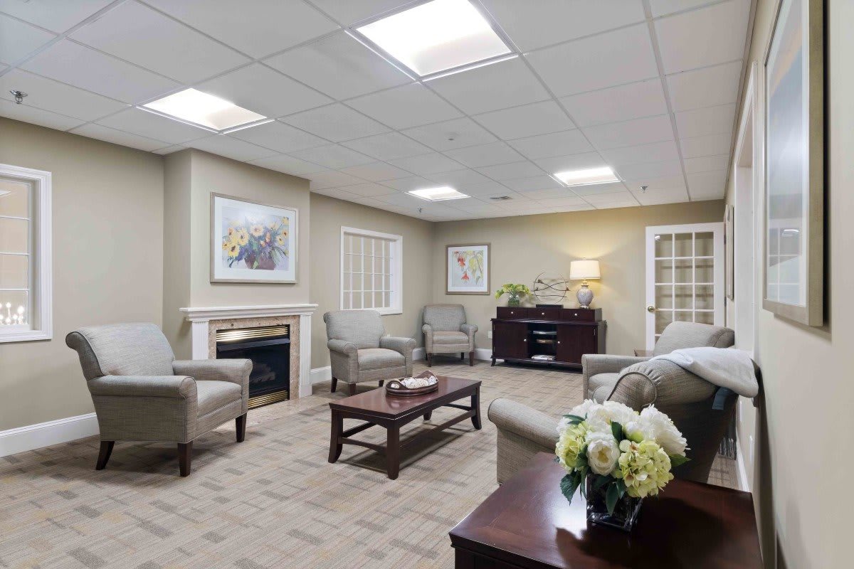 A well-furnished living room with comfortable seating, a coffee table, and a fireplace.