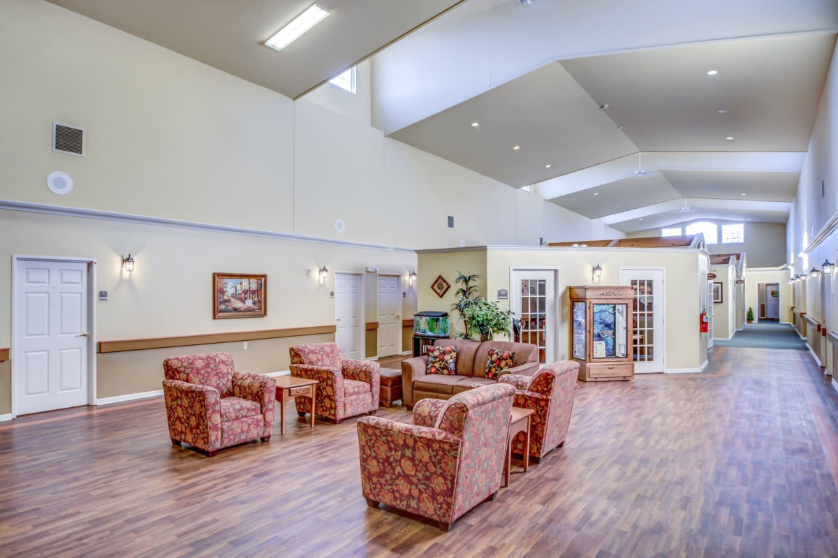 A spacious lobby with comfortable seating and wooden flooring.