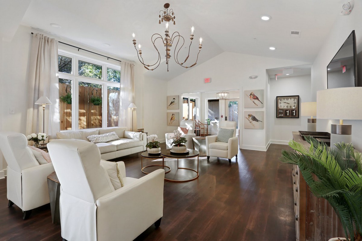 A modern living room with elegant decor and a large chandelier.