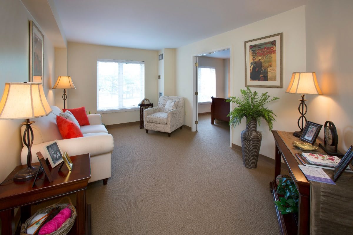 A cozy and well-lit living room with comfortable seating and tasteful decor.