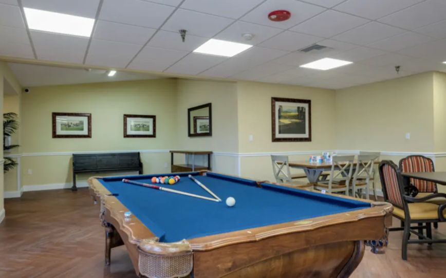 A cozy game room featuring a pool table and comfortable seating.