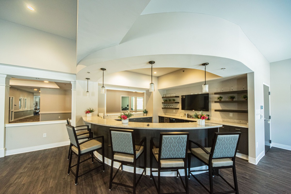 A modern kitchen with a circular bar counter and stylish seating.