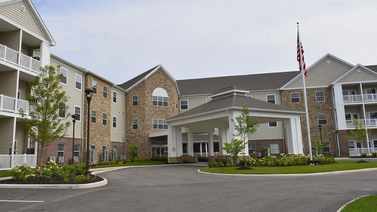 A modern residential building with a welcoming entrance and well-maintained landscaping.
