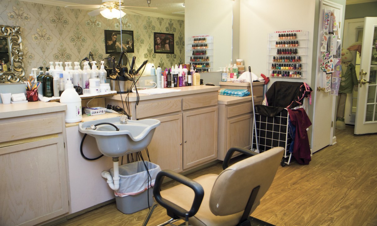 A cozy hair salon equipped with a variety of beauty products and a comfortable barber chair.