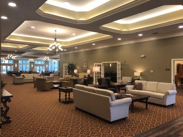 A spacious lobby area with elegant lighting and comfortable seating.