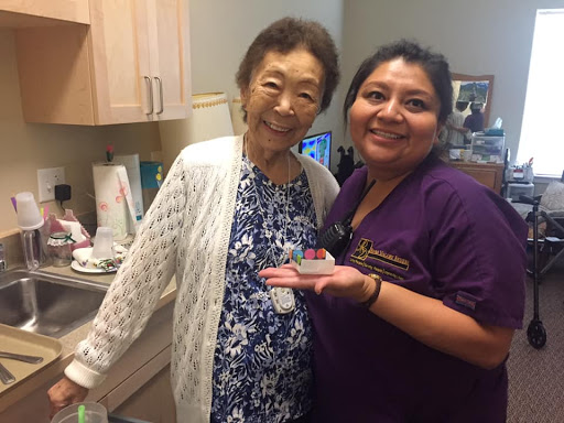 A joyful moment shared between an elderly woman and her caregiver.