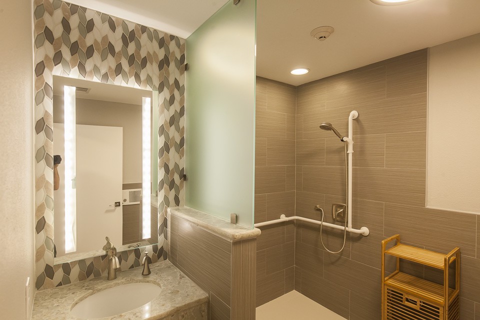 A modern bathroom with a walk-in shower and stylish tile design.