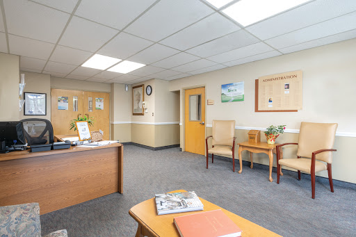 A welcoming office waiting area with a reception desk and comfortable seating.